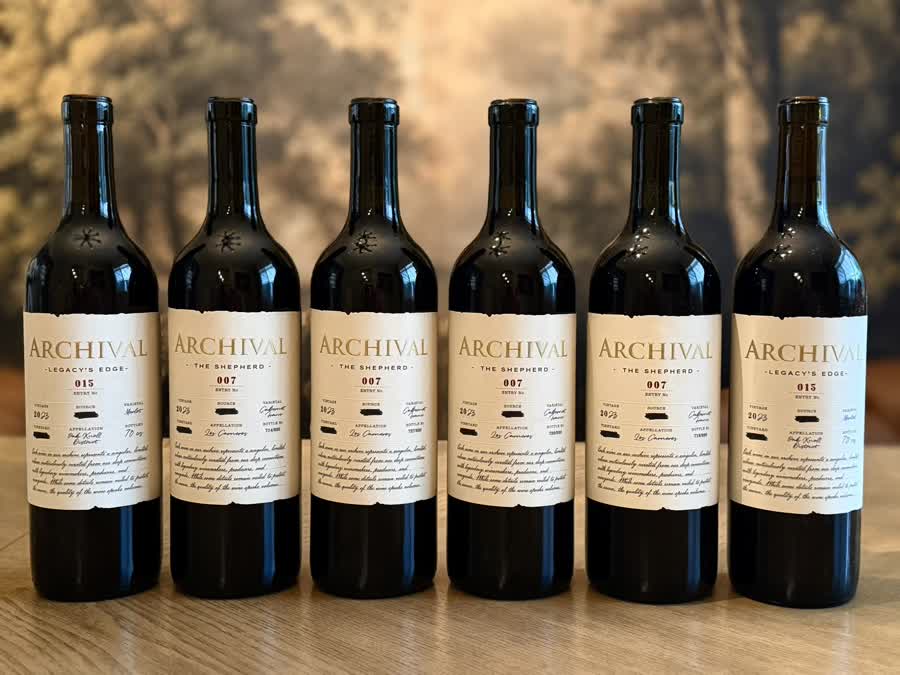 Six Archival bottles lined up on a table on delivery day